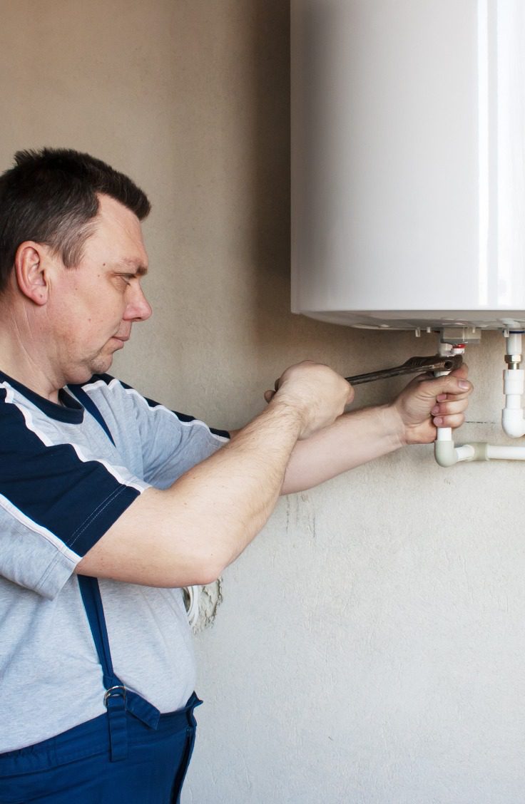 water-heater-repair man repairing a water heater